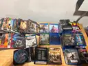 Mixed media lot including approximately +85 DVDs and Blu-ray movies, plus 4 video games for PlayStation 4 and Xbox One.