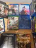 Mixed media lot including approximately +85 DVDs and Blu-ray movies, plus 4 video games for PlayStation 4 and Xbox One.