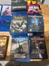 Mixed media lot including approximately +85 DVDs and Blu-ray movies, plus 4 video games for PlayStation 4 and Xbox One.