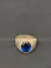 Mixed Lot- Sterling Silver Ring with Unverified Blue Stone, Rednote $1 Bill, and Other Currency