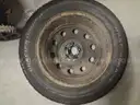 two studded snow tires with rims  Mastercraft Glacier Grip II 235/55R17