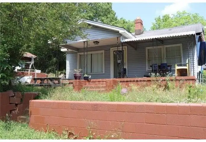 Charming residential home alongside a commercial building.