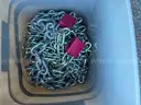 Bucket loaded with used metal chains with few locks very heavy