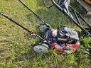 2 lawn mowers and Weed Eater