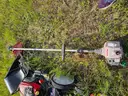 2 lawn mowers and Weed Eater