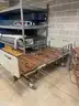 2 hospital beds without mattresses