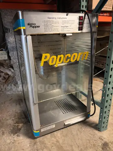 Two (2) Popcorn machines. Both work properly, one machine is missing the bottom door.