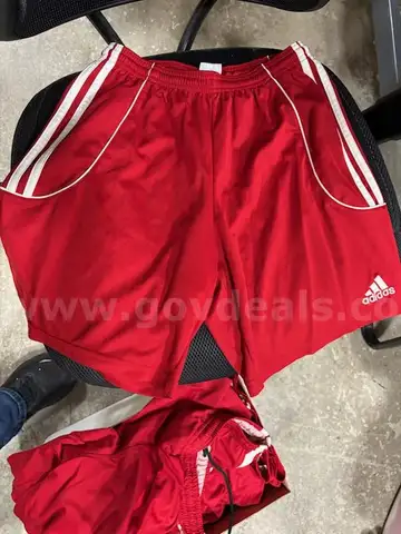 Various red and white women's adidas shorts
