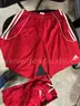 Various red and white women's adidas shorts