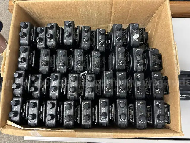 Lot of Motorola Minitor 5 pagers, chargers, cords, and programmer.