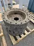 (4) SKID STEER TIRES AND WHEELS
