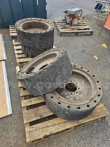 (4) SKID STEER TIRES AND WHEELS