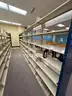 Lot containing various sizes, styles, and configurations library book and magazine shelving and book carts.