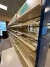 Lot containing various sizes, styles, and configurations library book and magazine shelving and book carts.