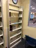 Lot containing various sizes, styles, and configurations library book and magazine shelving and book carts.