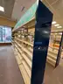 Lot containing various sizes, styles, and configurations library book and magazine shelving and book carts.