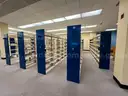 Lot containing various sizes, styles, and configurations library book and magazine shelving and book carts.