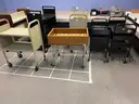 Lot containing various sizes, styles, and configurations library book and magazine shelving and book carts.