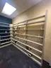 Lot containing various sizes, styles, and configurations library book and magazine shelving and book carts.