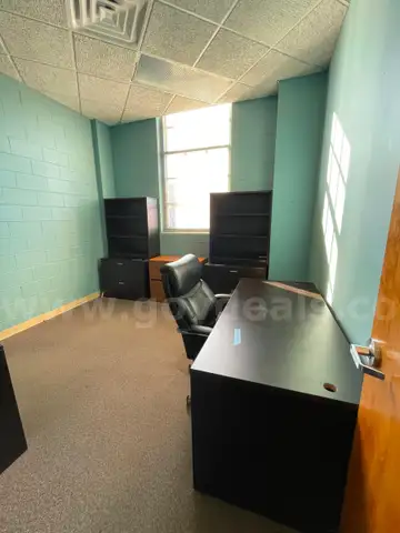 Lot containing office furniture, including desks, wood file cabinets, bookcases, and office chairs.