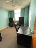 Lot containing office furniture, including desks, wood file cabinets, bookcases, and office chairs.