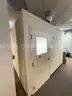 Freestanding PortaFab modular office room with lighting, power, and enclosed workspace.