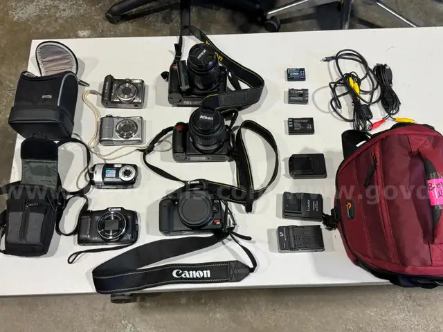 Lot of various cameras, consumer electronics, networking routers, photography equipment