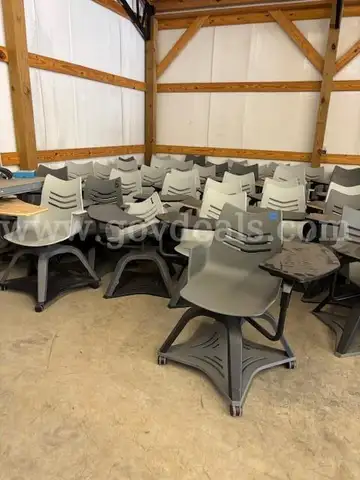 1 lot of approximately 65 plastic student desks with attached chairs