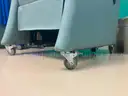 Padded reclining chair on wheels