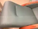 Padded reclining chair on wheels