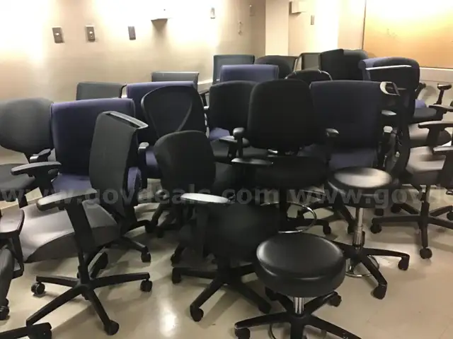 Lot of 26 rolling office chairs and 2 stools