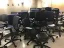 Lot of 26 rolling office chairs and 2 stools