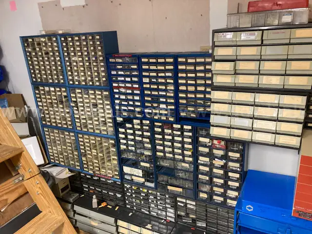 Small electrical parts for repair of medical equip - includes metal shelves with small plastic drawers