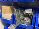 Spare parts for repair of medical equip - includes metal shelves with plastic bins