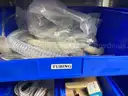 Spare parts for repair of medical equip - includes metal shelves with plastic bins
