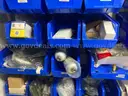 Spare parts for repair of medical equip - includes metal shelves with plastic bins