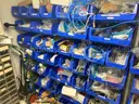 Spare parts for repair of medical equip - includes metal shelves with plastic bins