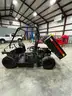 UTV with manual dump bed.