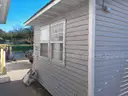 Lot of a Portable Office Building, Misc. Office Furniture, and an AC Unit.