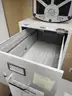 Bookshelf, White Plastic File Cabinet, and Five-Drawer Vertical File Cabinet