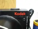 (1) USED BLACK, KODAK EASYSHARE Z8612 IS CAMERA W/ 2-KODAK BATTERIES