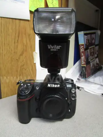 (1) USED BLACK, NIKON DIGITAL CAMERA D300, BODY ONLY; (1) USED BLACK, VIVITAR SERIES 1 FLASH ATTACHMENT, DF-383-NIK