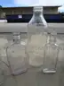 (18) USED GLASS BOTTLES; (1) USED PULL-TAB CAN