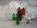 (18) USED GLASS BOTTLES; (1) USED PULL-TAB CAN