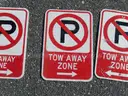 USED (6) TOW AWAY ZONE SIGNS, (3) CAUTION SIGNS, (1) ALL WAY SIGN