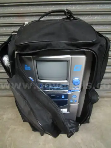 (1) USED CONCOURSE SUITCASE WITH THE SINGING MACHINE KARAOKE, STVG-700 &#x26; A MICROPHONE INSIDE