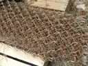 USED (6) BUNDLES OF CHAIN LINK OR CATTLE FENCING, (2) CHAIN LINK FENCING POSTS, (1) BOX OF ASSORTED FENCING HARDWARE