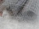 USED (6) BUNDLES OF CHAIN LINK OR CATTLE FENCING, (2) CHAIN LINK FENCING POSTS, (1) BOX OF ASSORTED FENCING HARDWARE