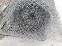 USED (6) BUNDLES OF CHAIN LINK OR CATTLE FENCING, (2) CHAIN LINK FENCING POSTS, (1) BOX OF ASSORTED FENCING HARDWARE