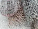 USED (6) BUNDLES OF CHAIN LINK OR CATTLE FENCING, (2) CHAIN LINK FENCING POSTS, (1) BOX OF ASSORTED FENCING HARDWARE